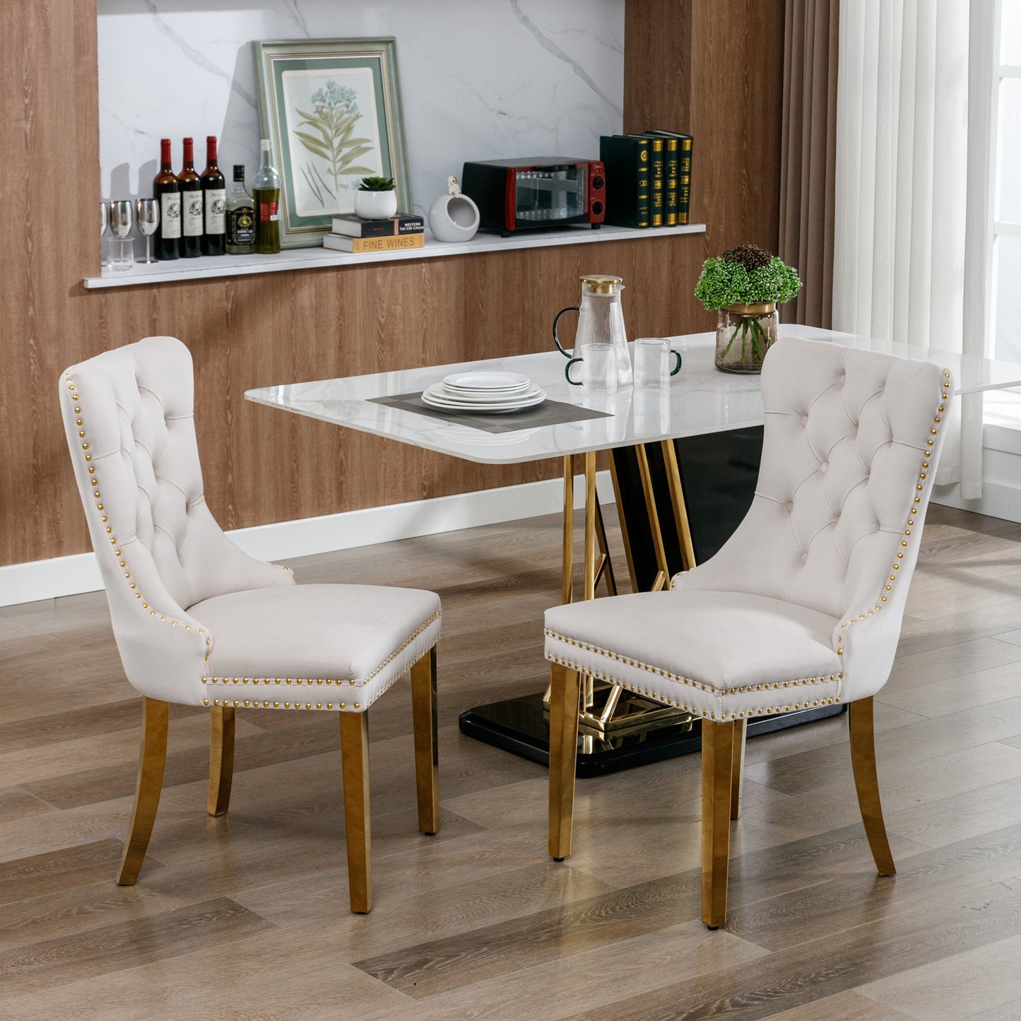 Cream upholstered dining chair with gold nailhead trim and gold legs