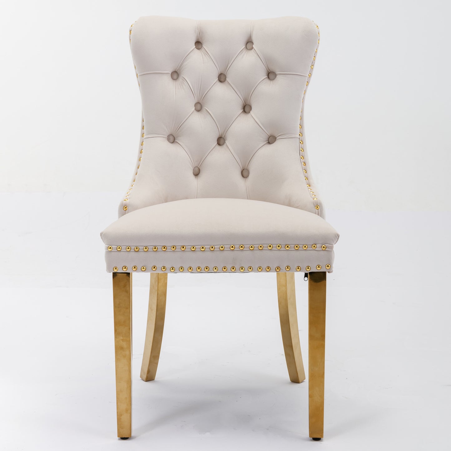 Beige velvet dining chair with tufted back and gold nailhead trim