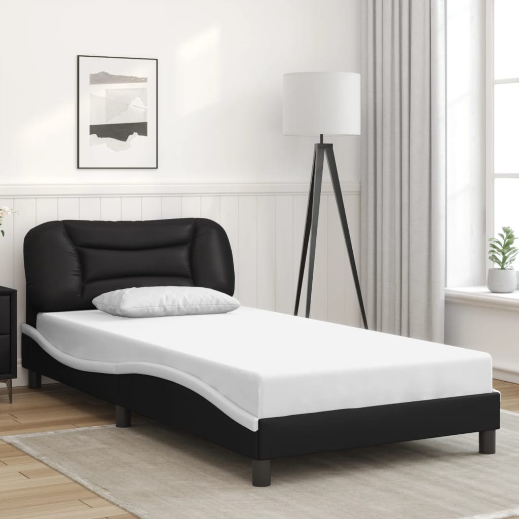 Modern black faux leather twin bed frame with curved headboard and wooden slats