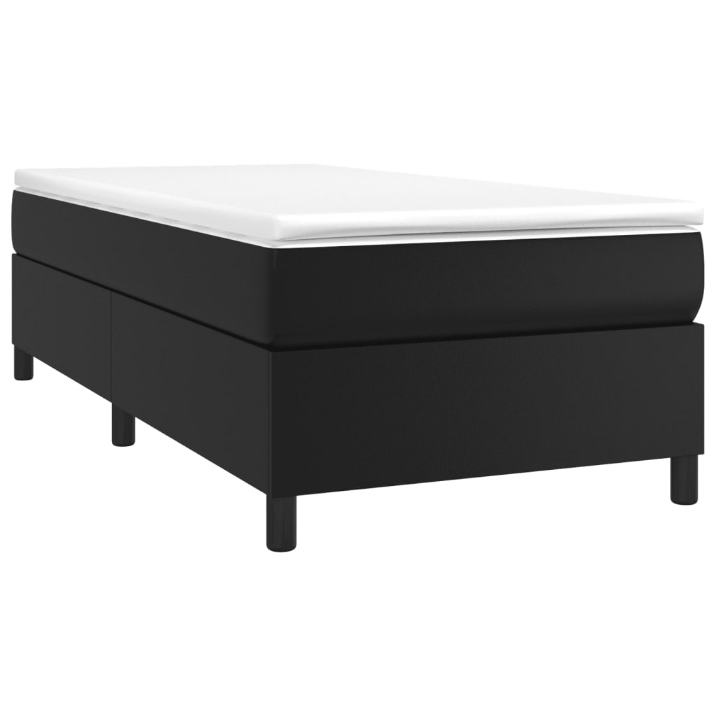 Black upholstered bed frame with a white mattress topper