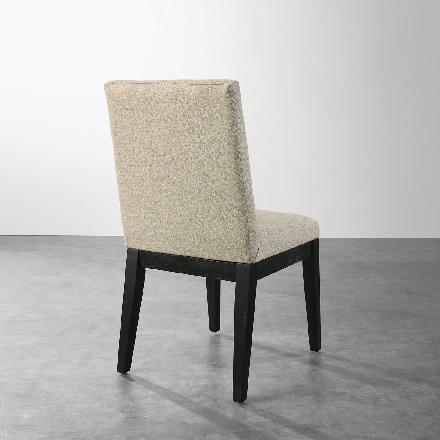 Beige upholstered dining chair with dark wood legs