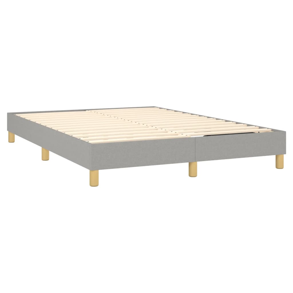 Gray upholstered bed frame with white mattress and wooden legs