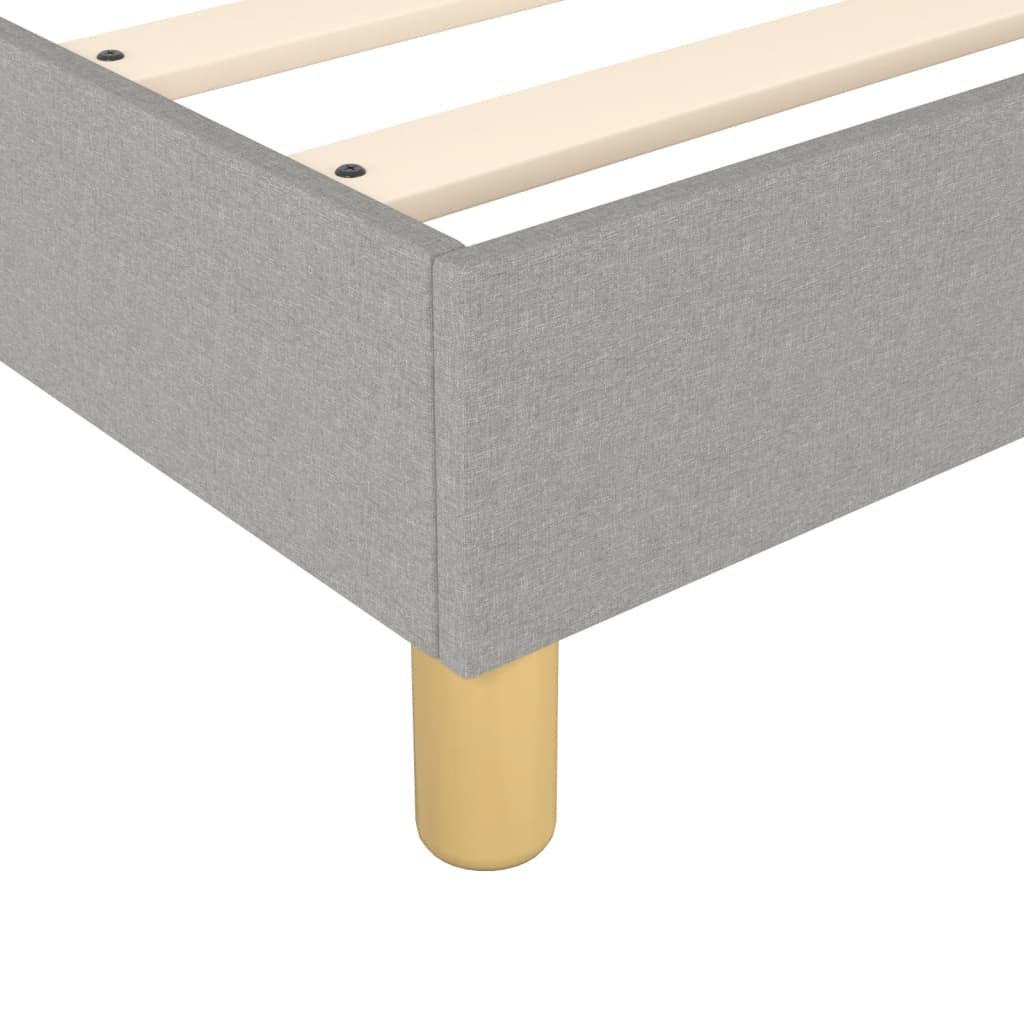 Gray upholstered platform bed frame with wooden slats and natural wood legs