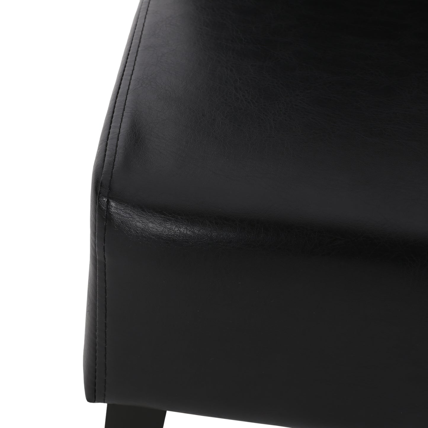 Black leather chair detail with visible stitching