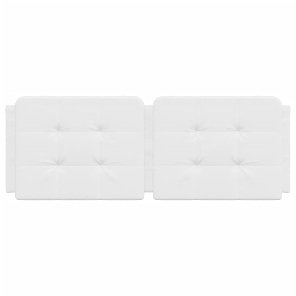 White tufted upholstered headboard panels mounted above a bed