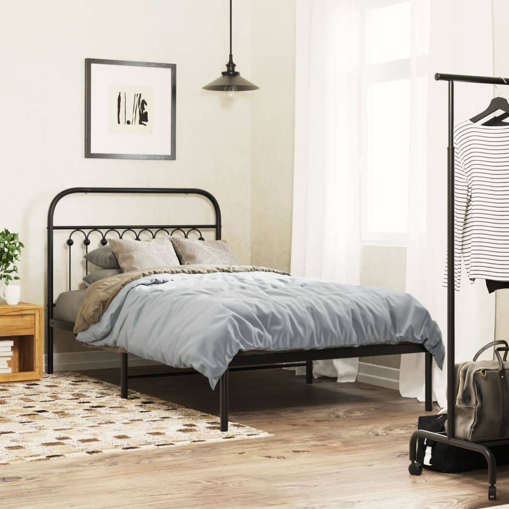 Black metal twin bed frame with curved headboard and decorative finials