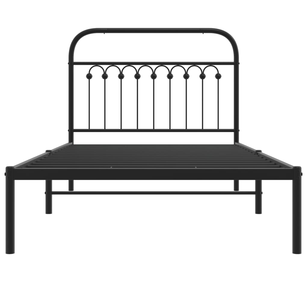 Black metal twin bed frame with ornate headboard