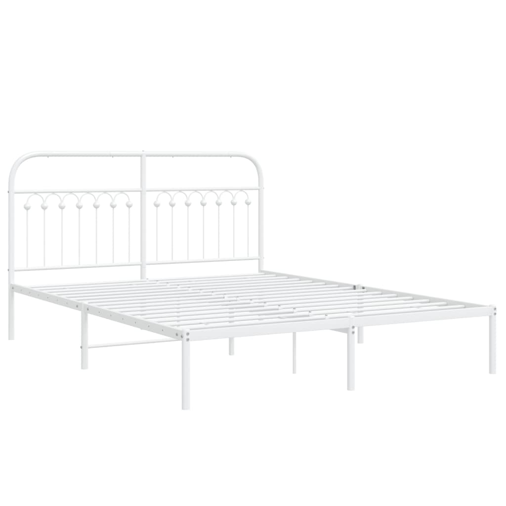 White metal queen bed frame with decorative headboard and neutral bedding