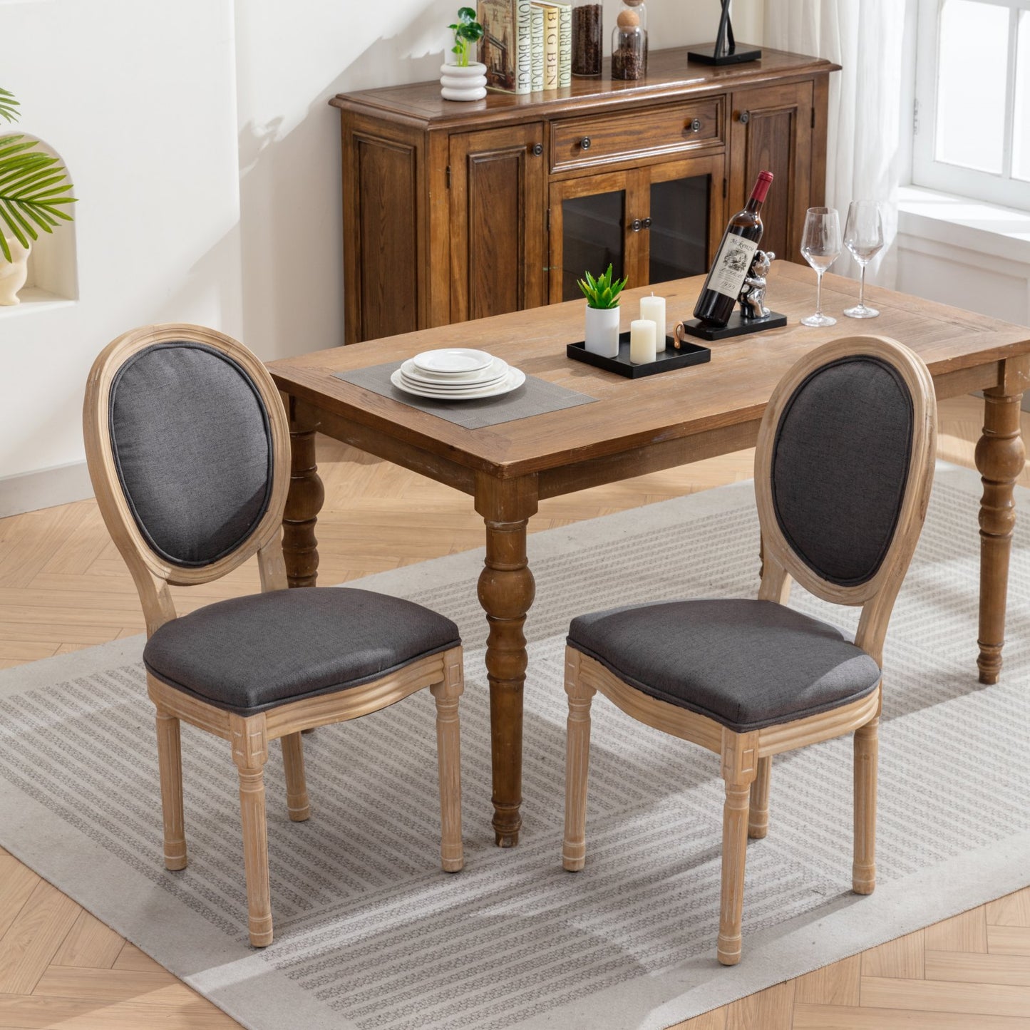 Grey upholstered oval back dining chair with light wood frame