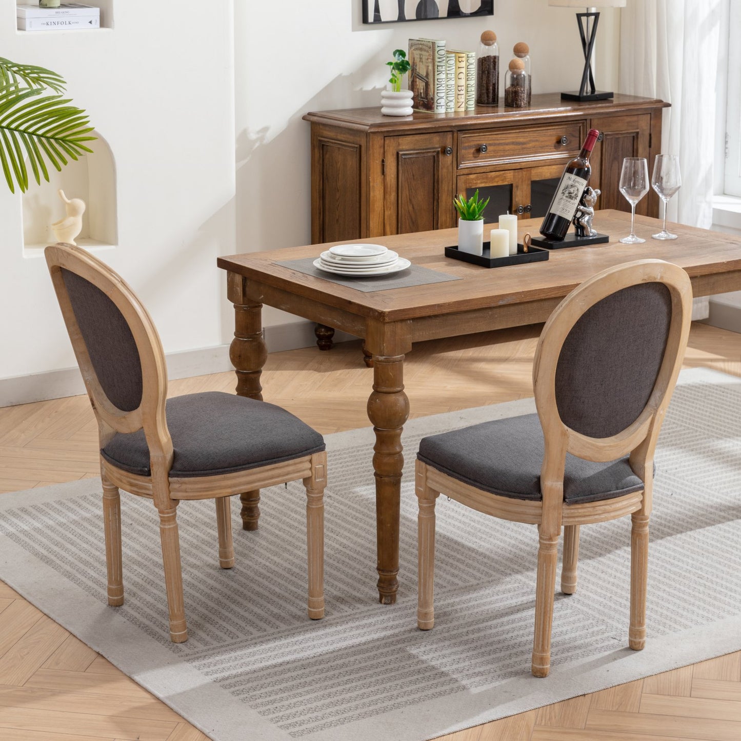 French country dining chair with carved wood frame and dark gray upholstered seat