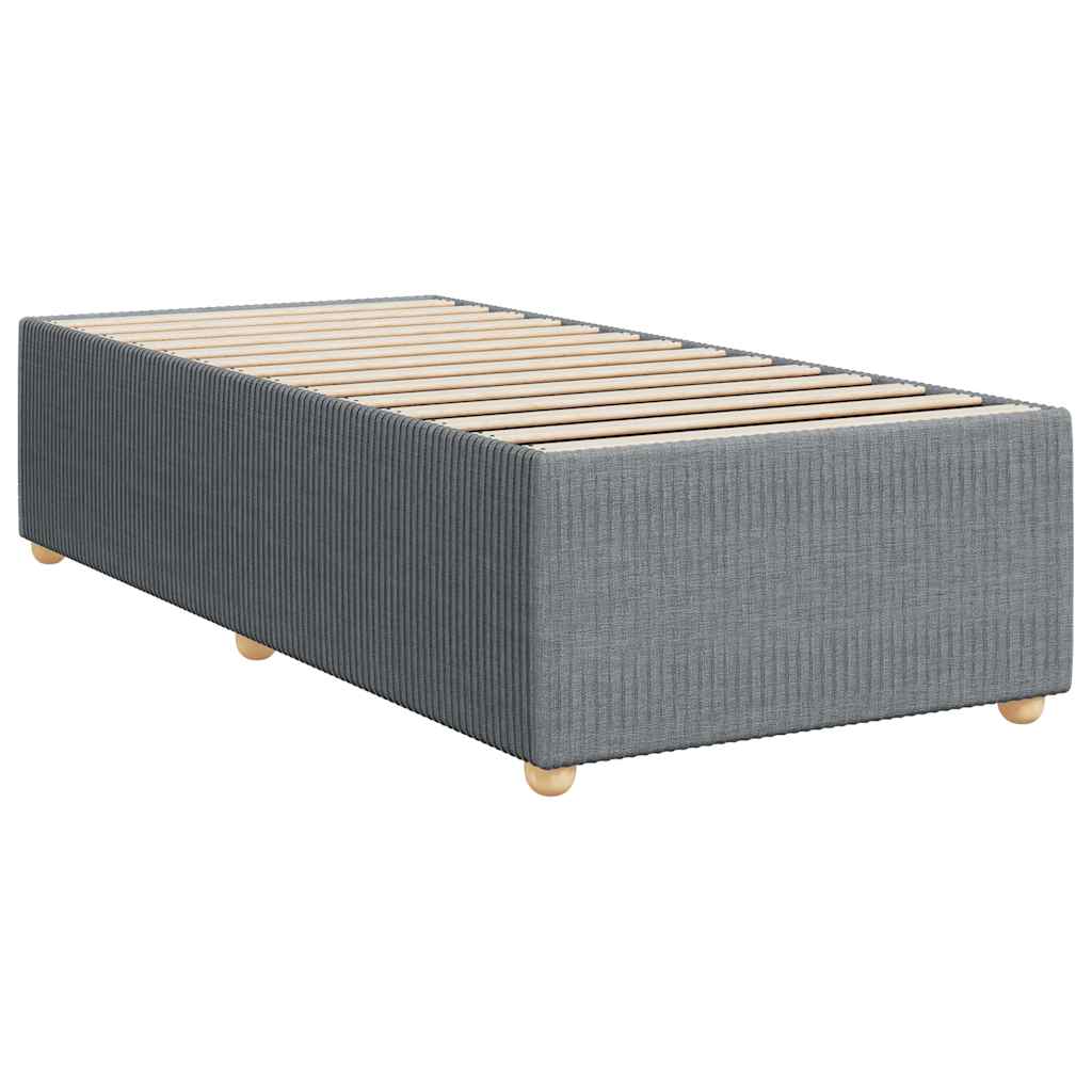 Grey divan bed with white duvet and mattress