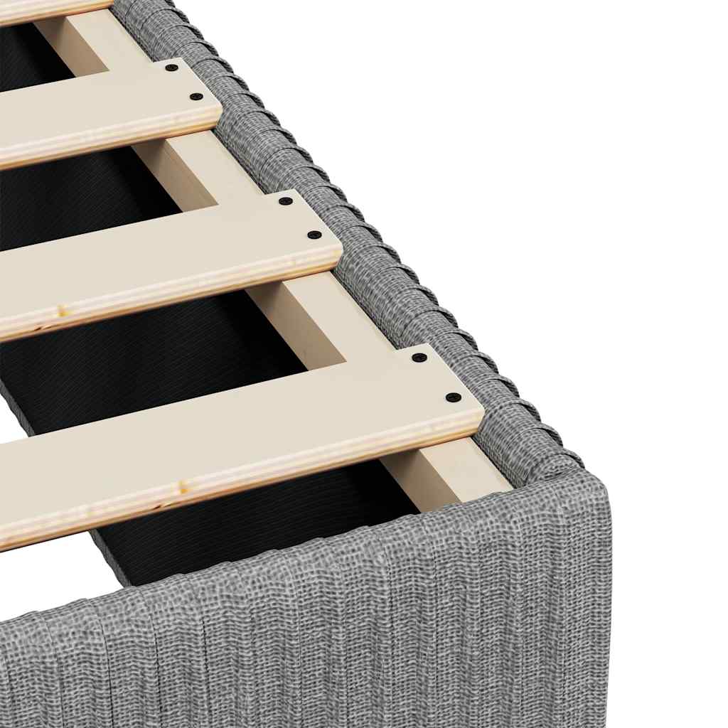 Grey upholstered divan bed base with wooden slats
