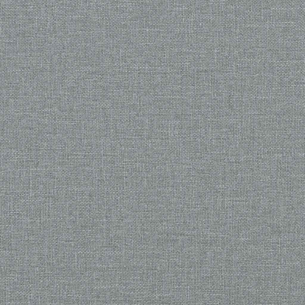 Closeup of a grey fabriccovered ottoman frame with visible wooden slats and supports