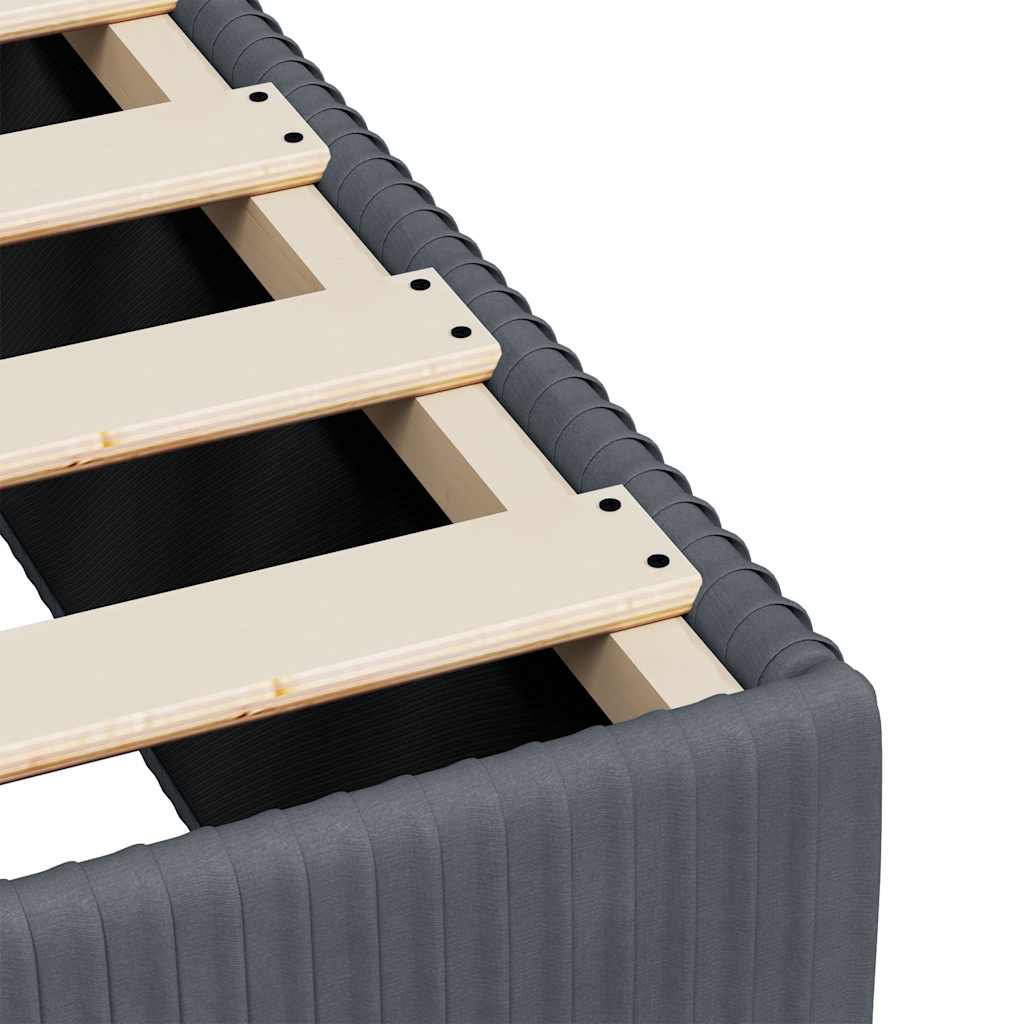 Grey upholstered divan bed base with a slatted wooden top and round feet