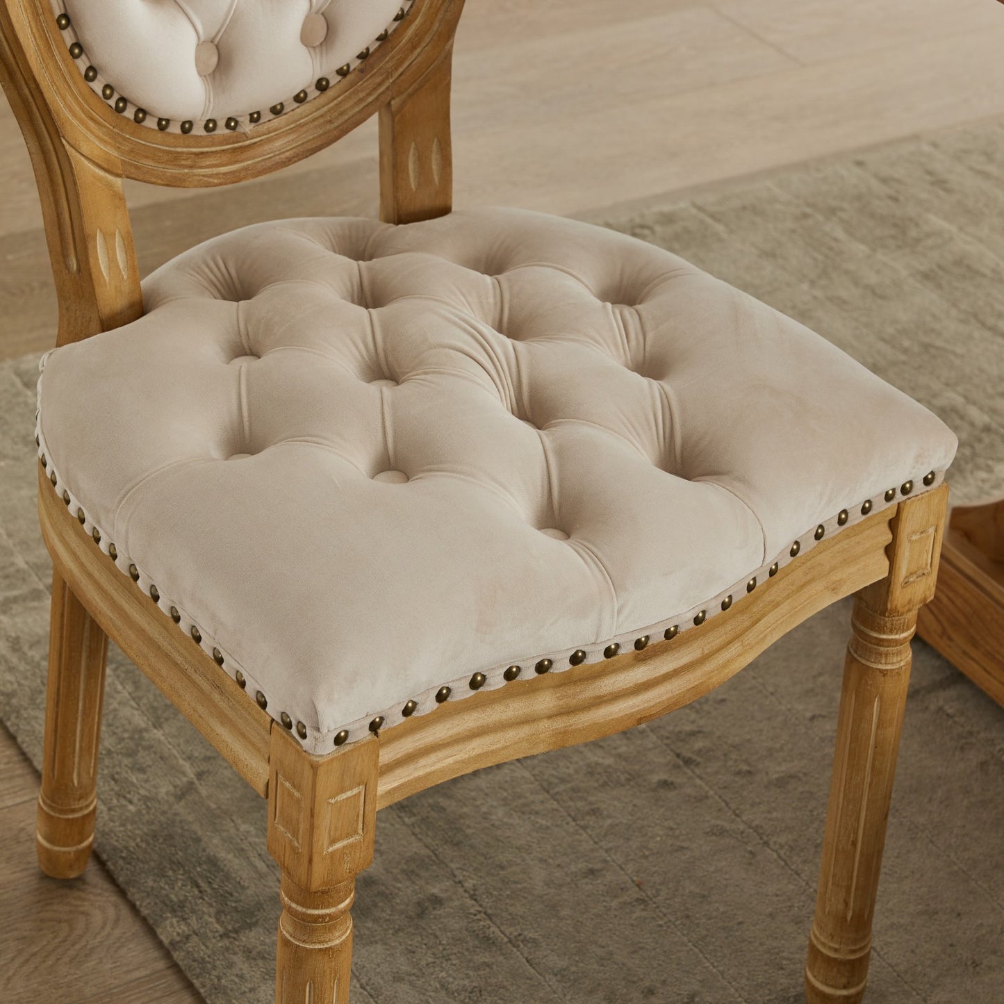 Tufted beige velvet accent chair with distressed wood frame