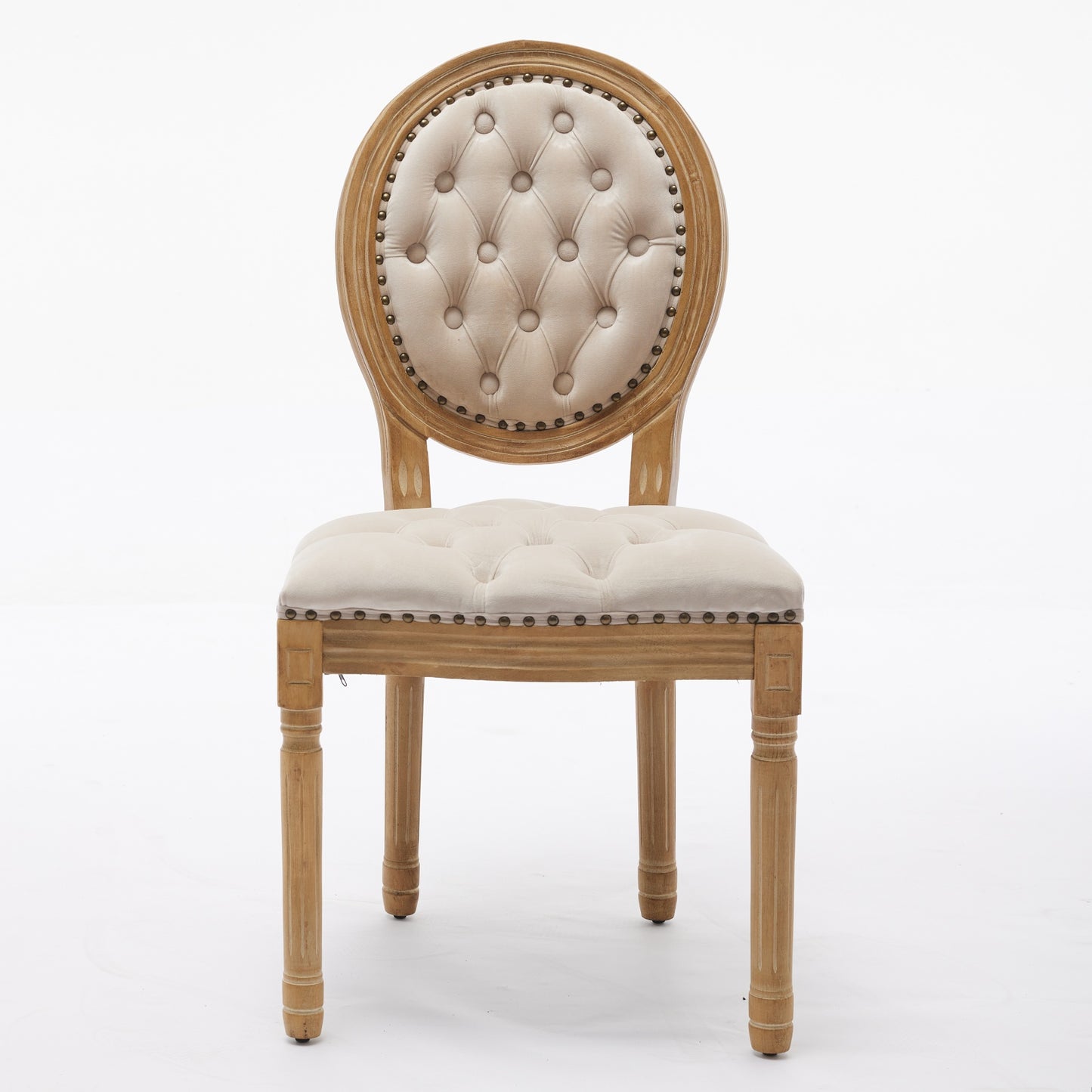 Tufted cream velvet dining chair with light wood frame and brass nailhead trim