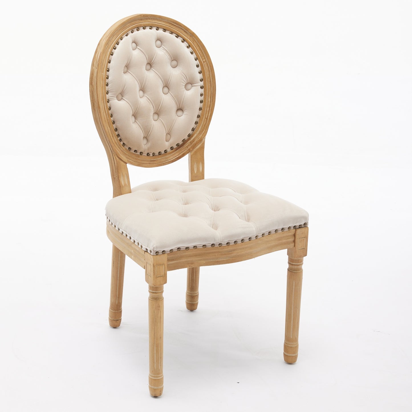 Tufted cream linen accent chair with a distressed wood frame and antique nailhead trim