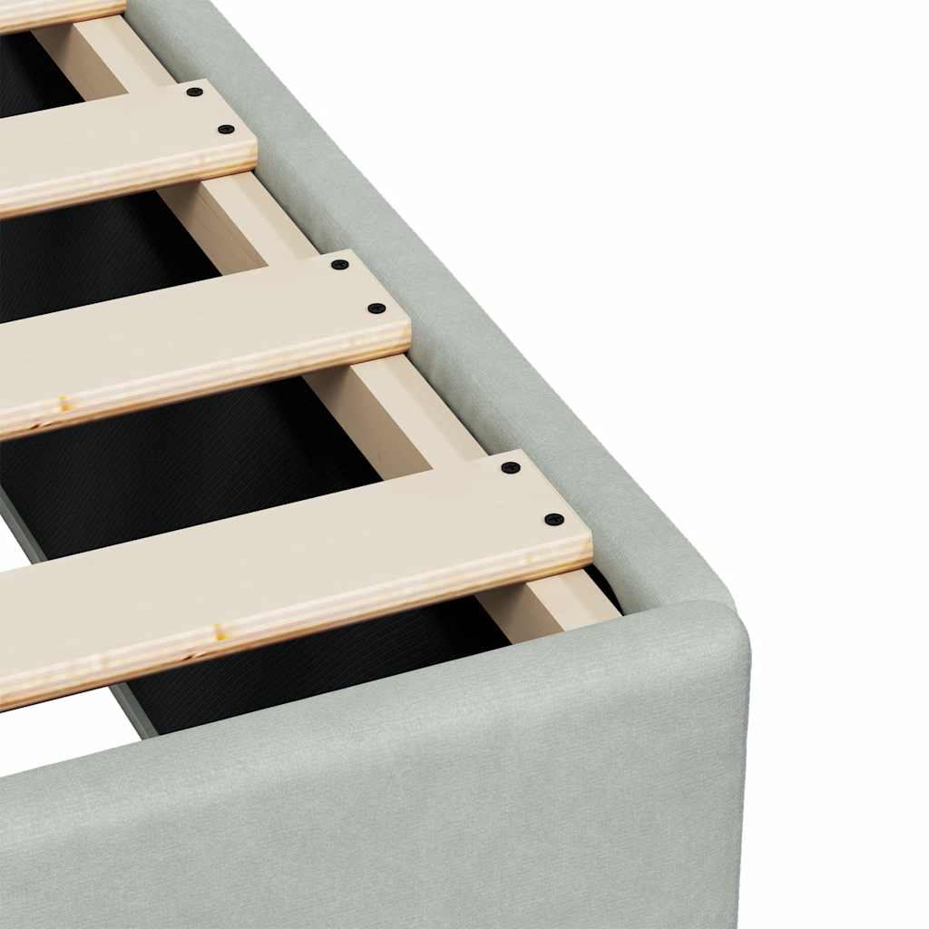 Light gray upholstered single bed base with wooden slats
