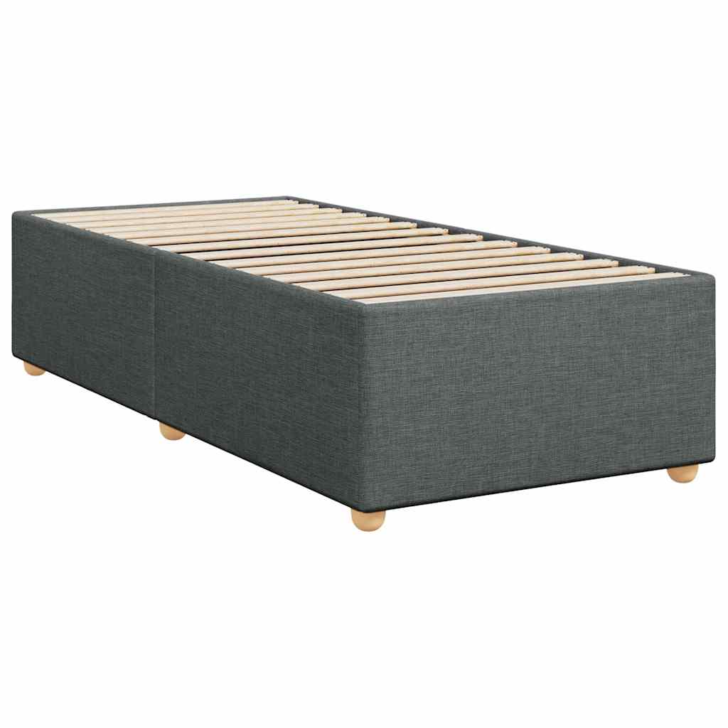 Grey fabric divan bed base with white mattress and bedding