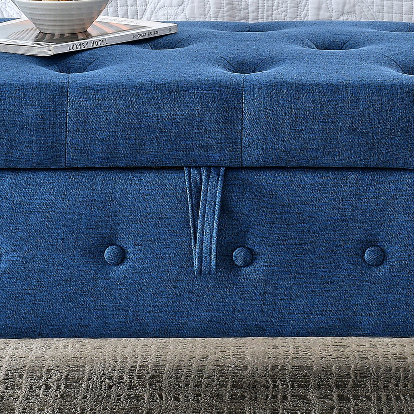 Deep blue linen tufted ottoman with decorative button detail