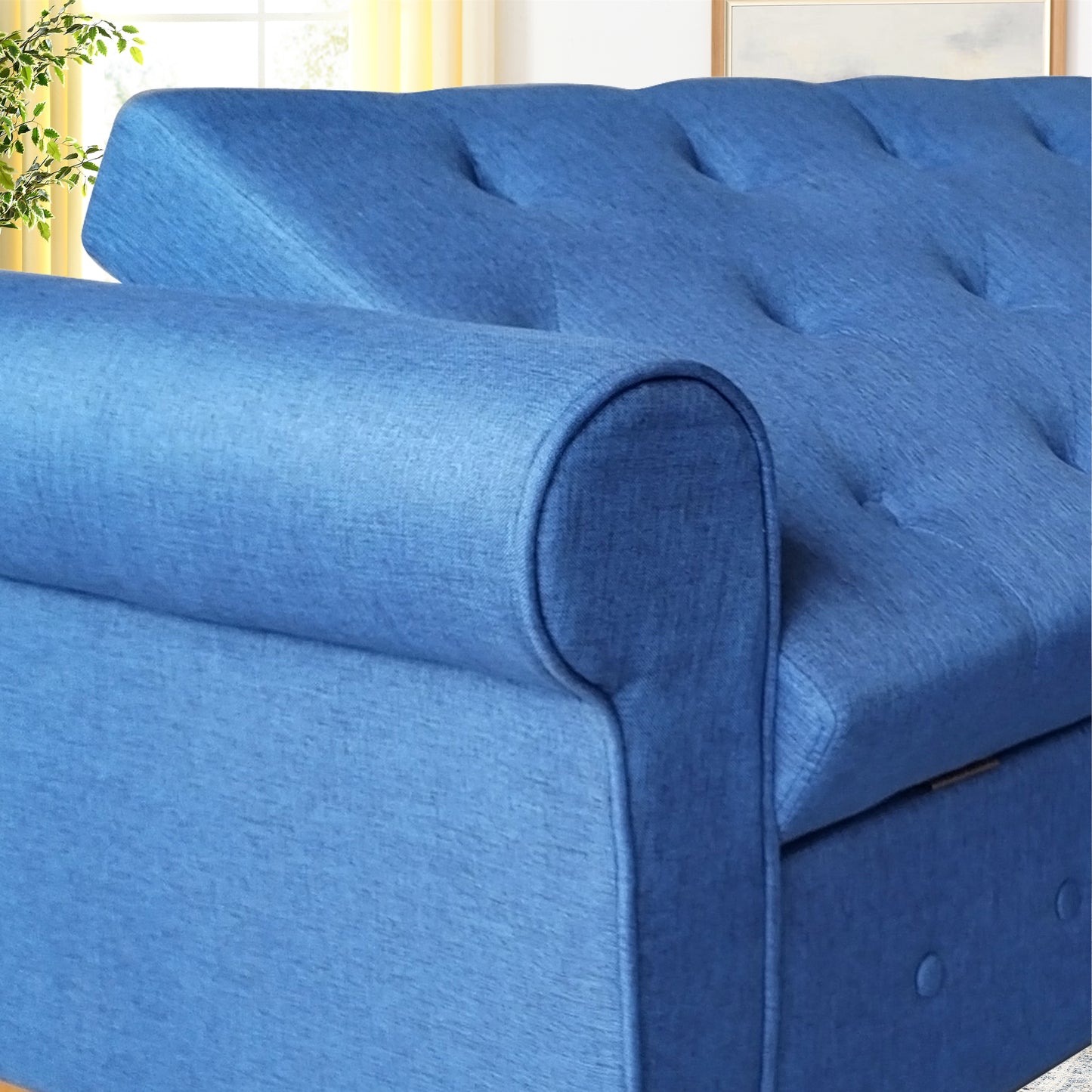 Blue upholstered sofa with tufted back cushions and rolled arms