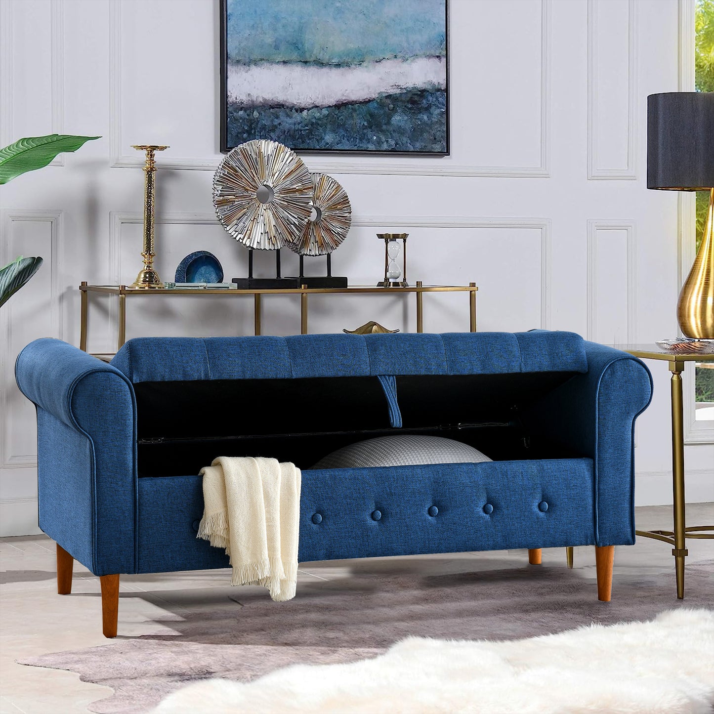 Blue tufted storage bench with roll arms and wooden legs