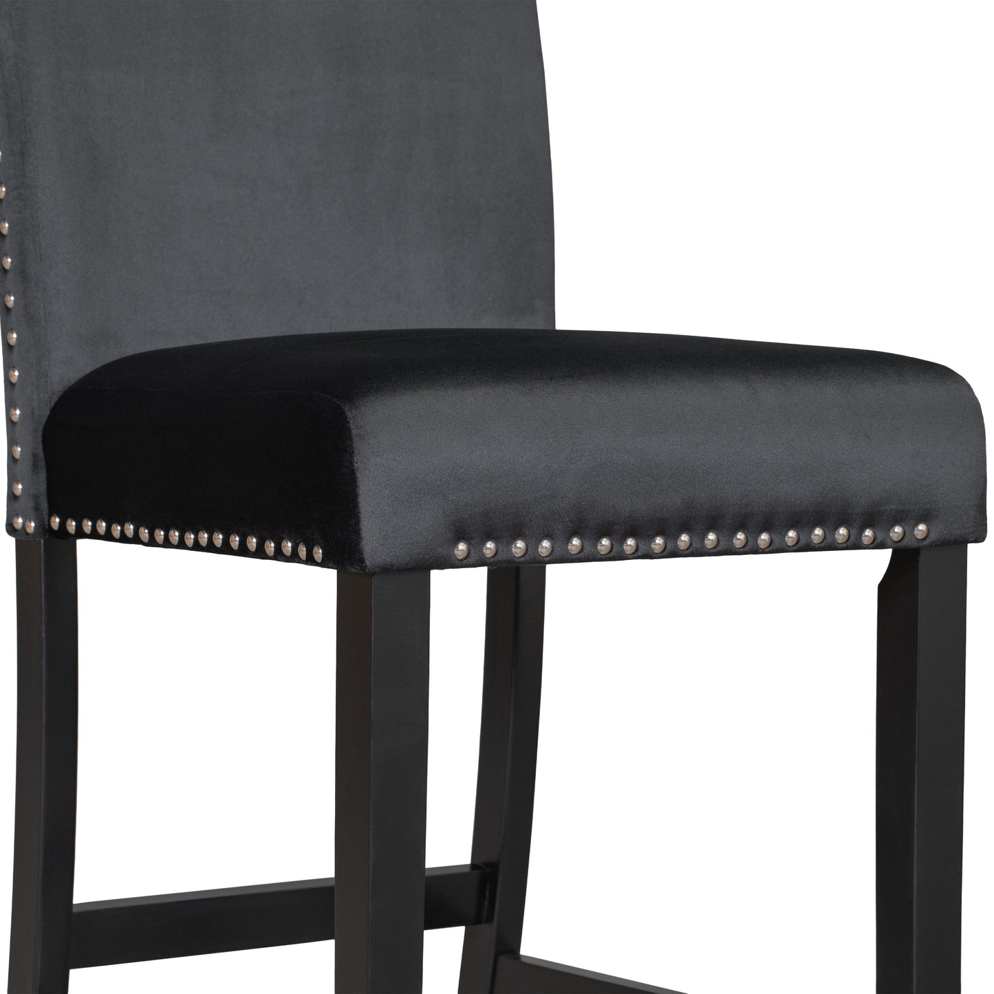 Closeup of a grey velvet tufted bar stool with silver nailhead trim and black wooden legs