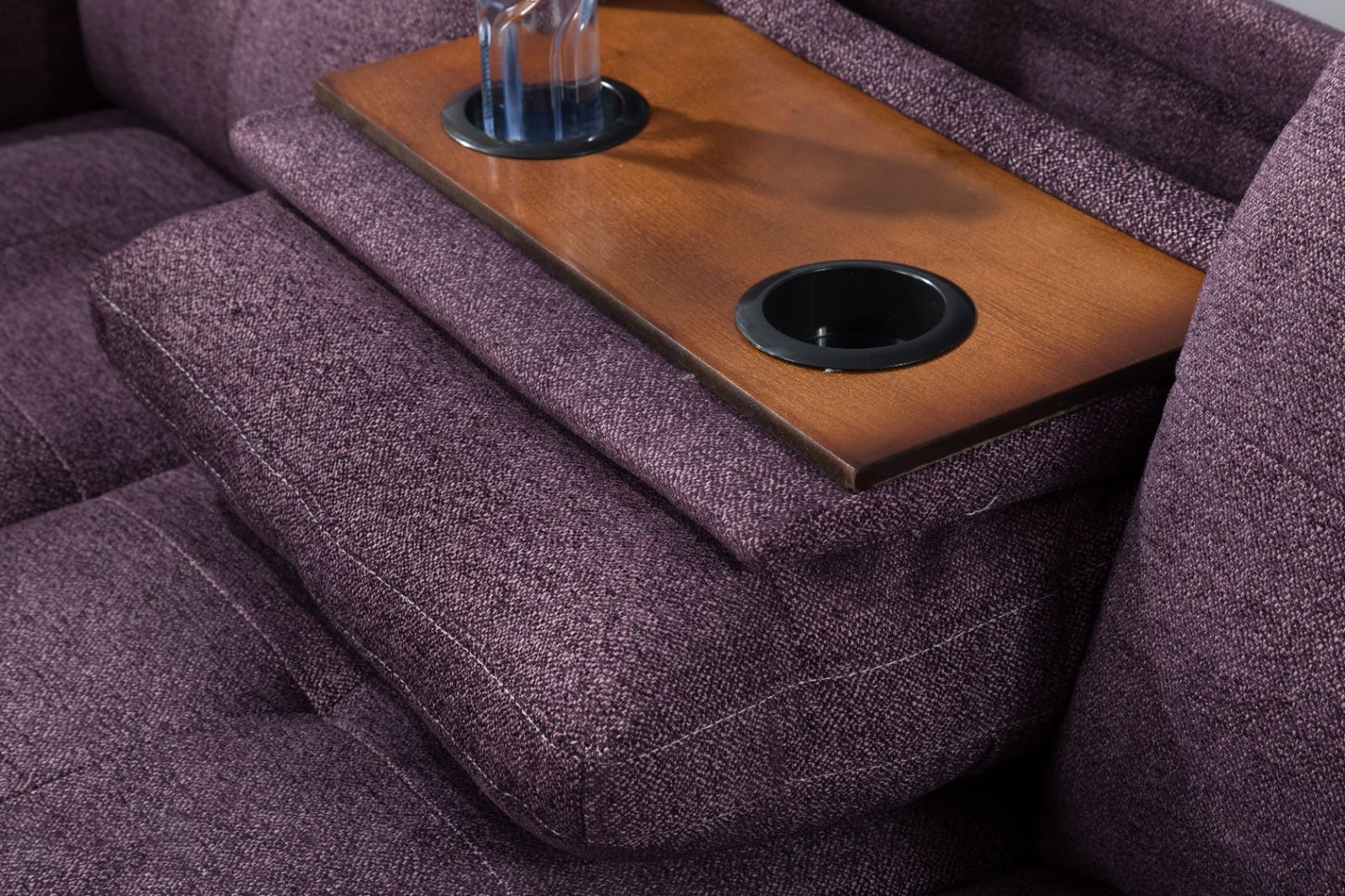 Purple fabric reclining sofa with wooden armrest tray cup holders for entertainment