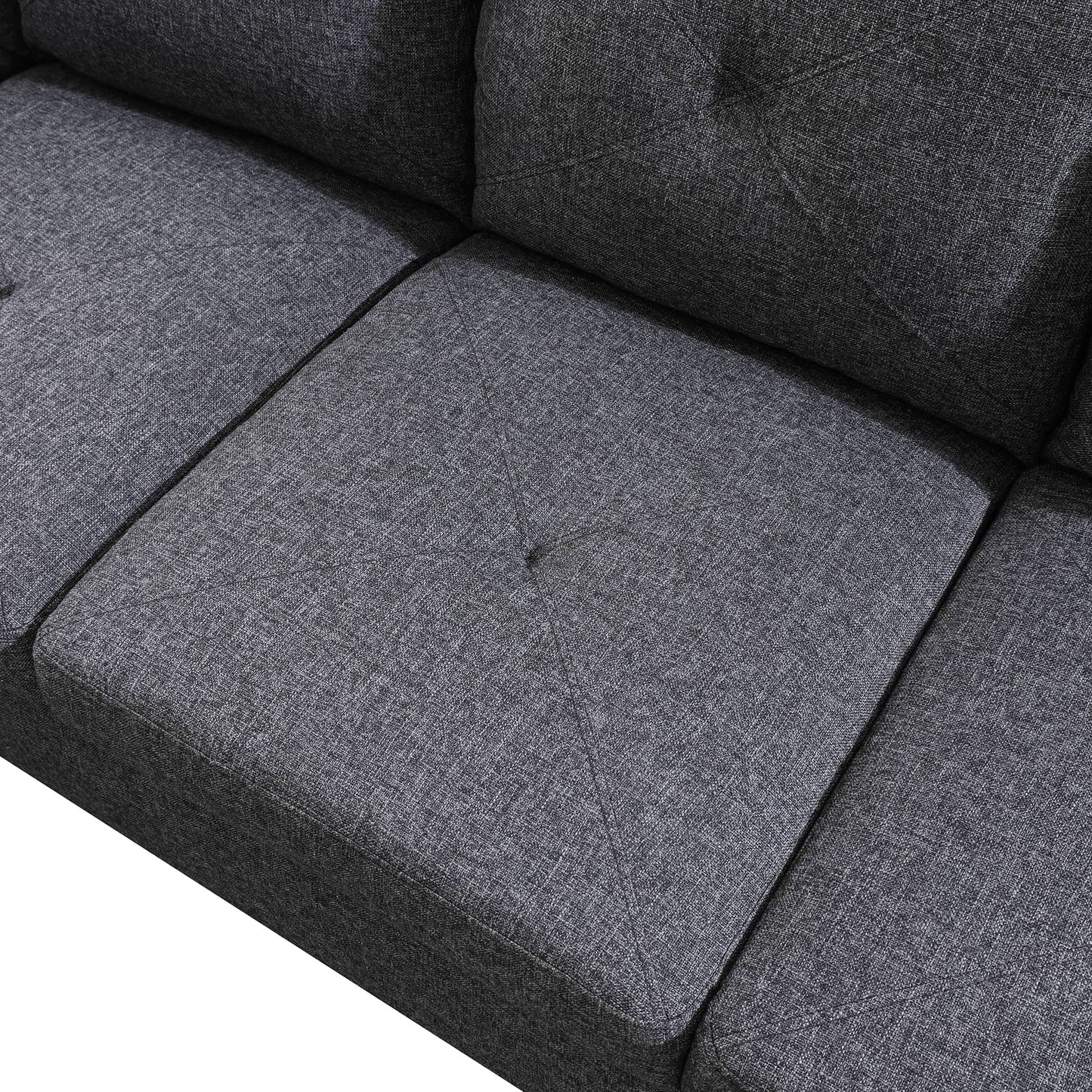 Dark grey fabric sofa detail with tufted cushions