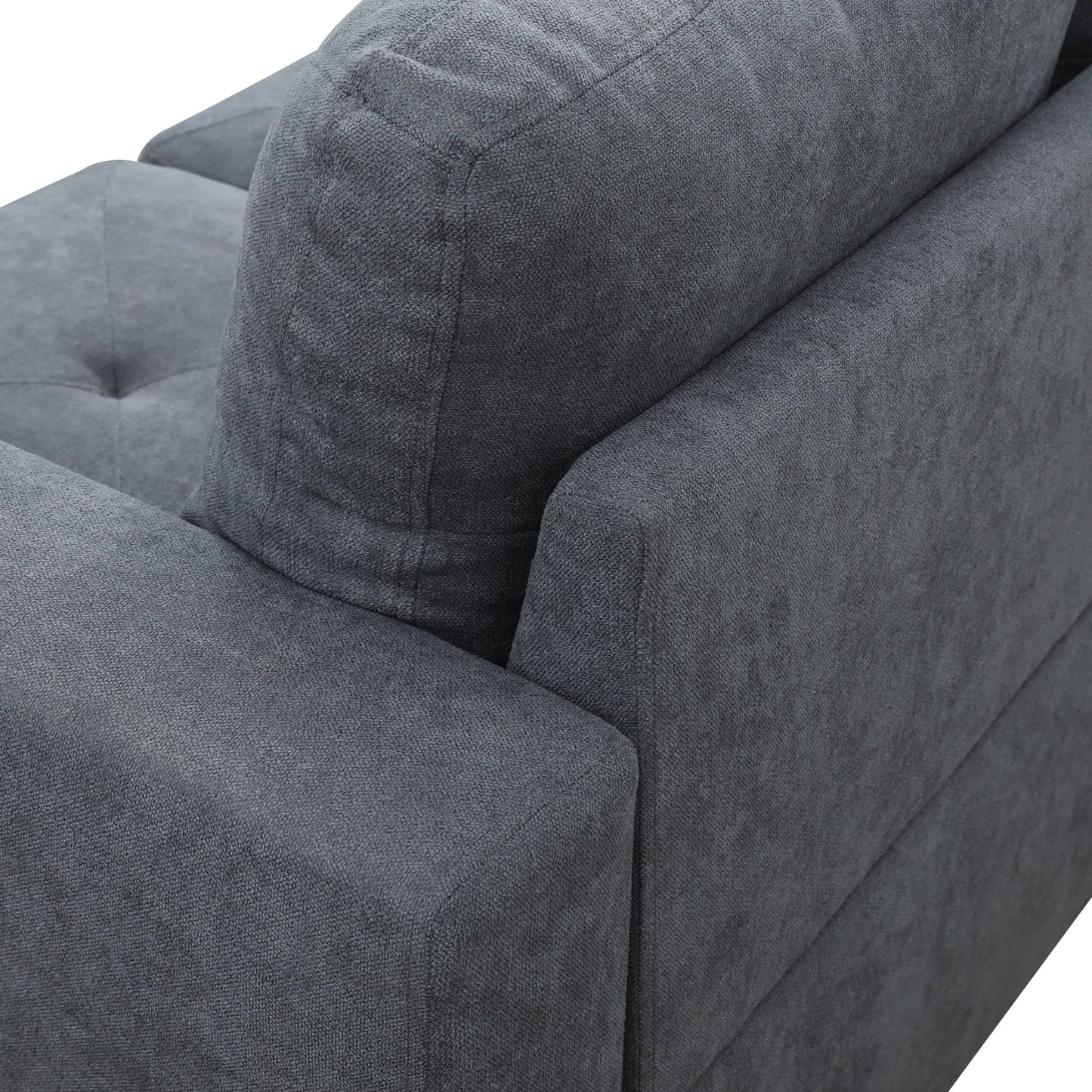 Closeup of a textured charcoal grey fabric sofa armrest and cushion