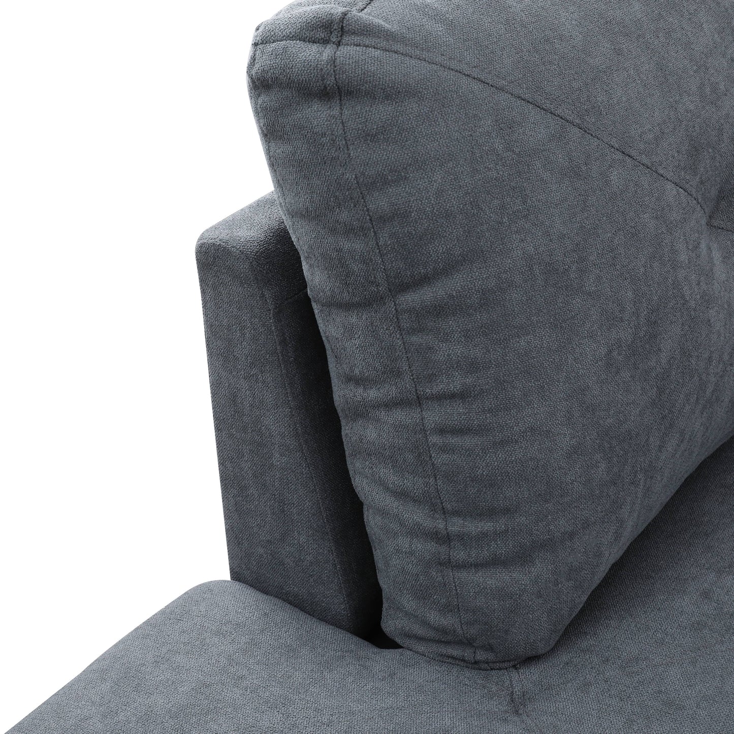Close up of a dark grey fabric sofa cushion with tufted detail