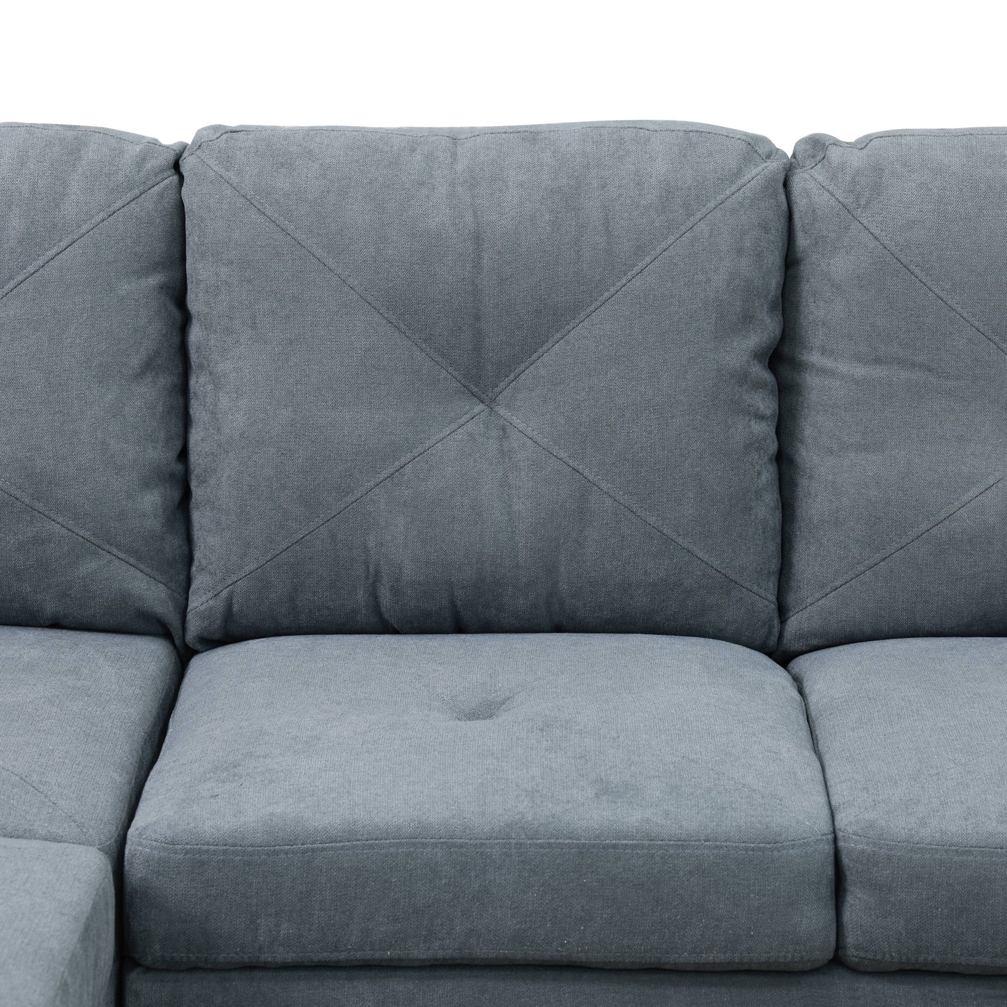 Close up of grey fabric sofa with diamond tufting on cushions