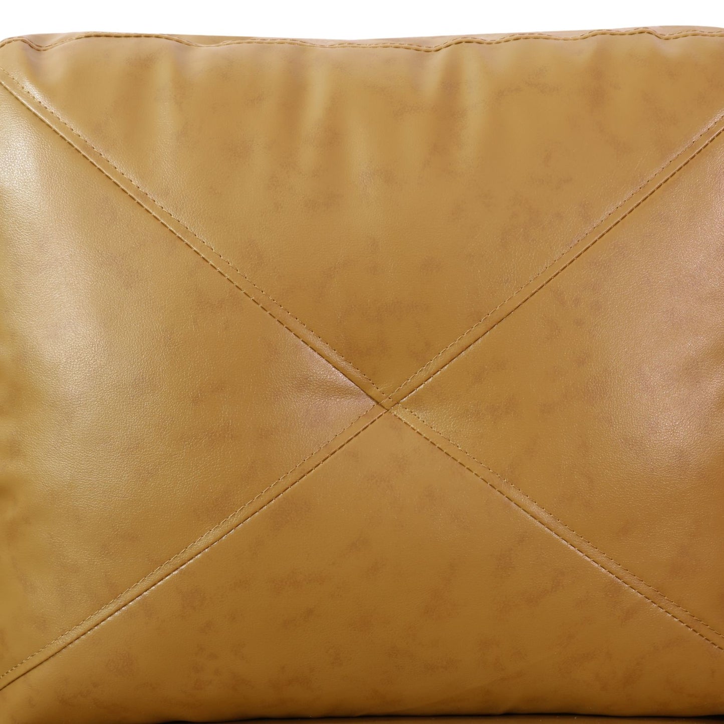 Closeup of tan leather armchair cushion with diamond stitching