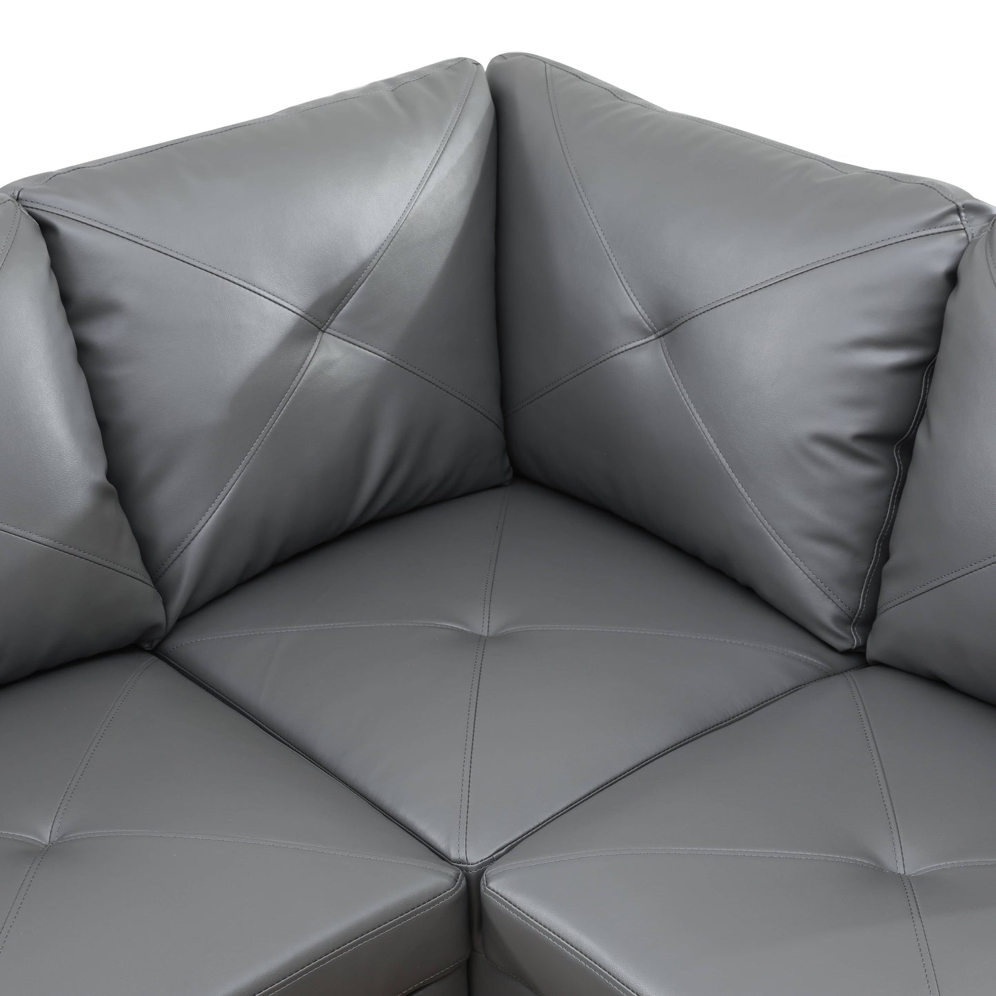 Closeup of gray faux leather sectional sofa corner