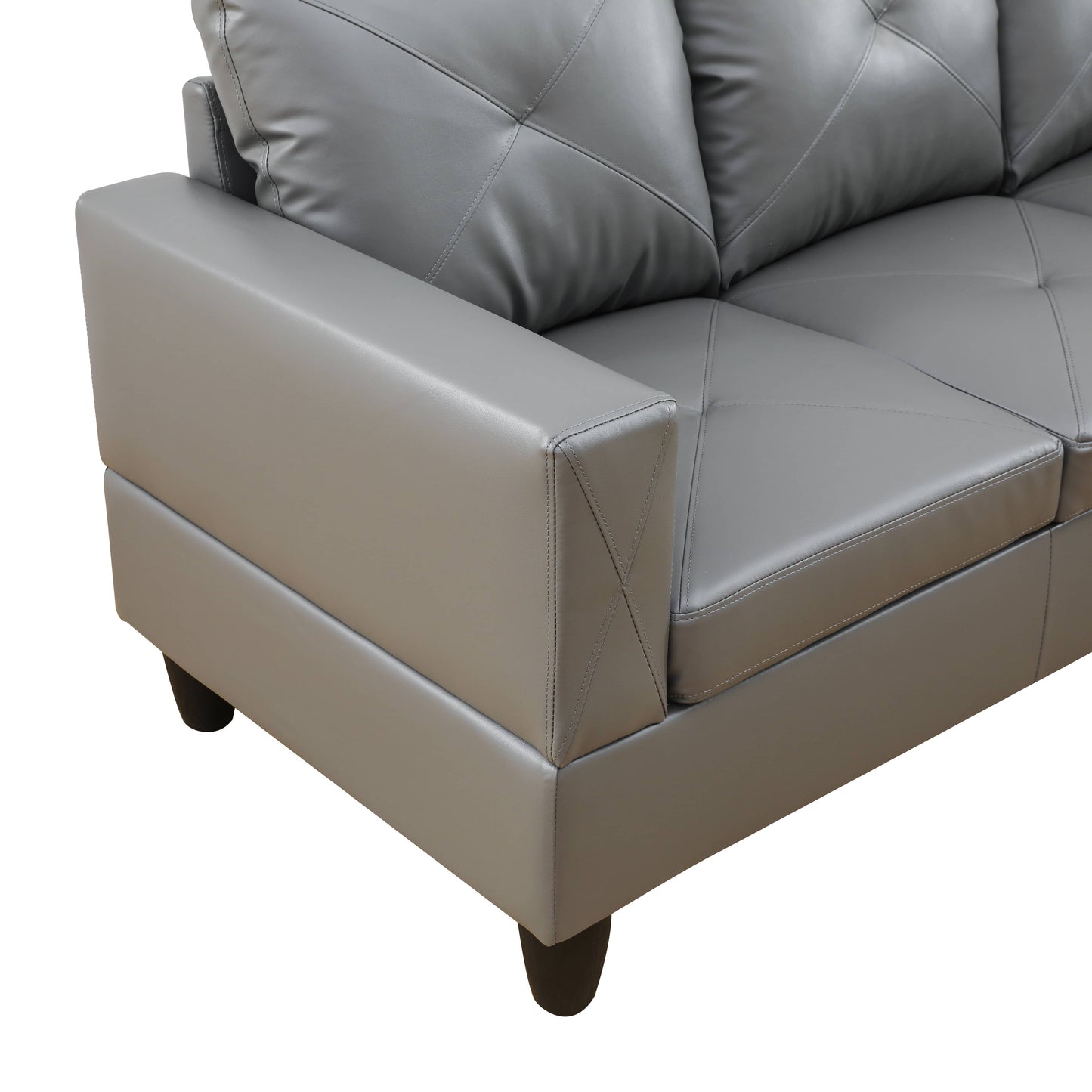 Gray faux leather sofa armrest detail with diamond tufting