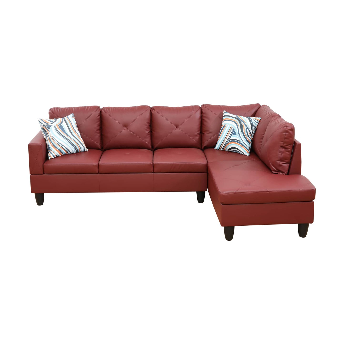 Red faux leather sectional sofa with diamond tufting and patterned throw pillows