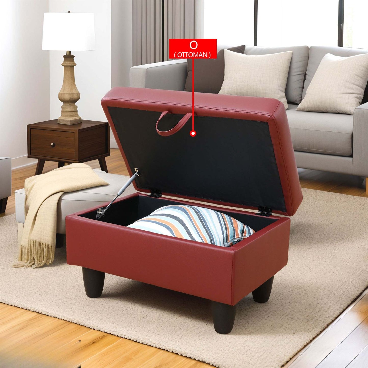 Red faux leather storage ottoman with black interior and pillow