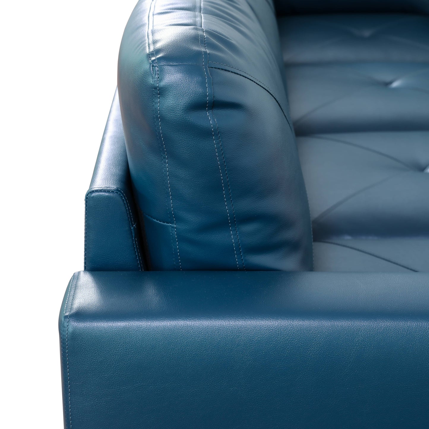 Teal leather sofa armrest with tufted cushions