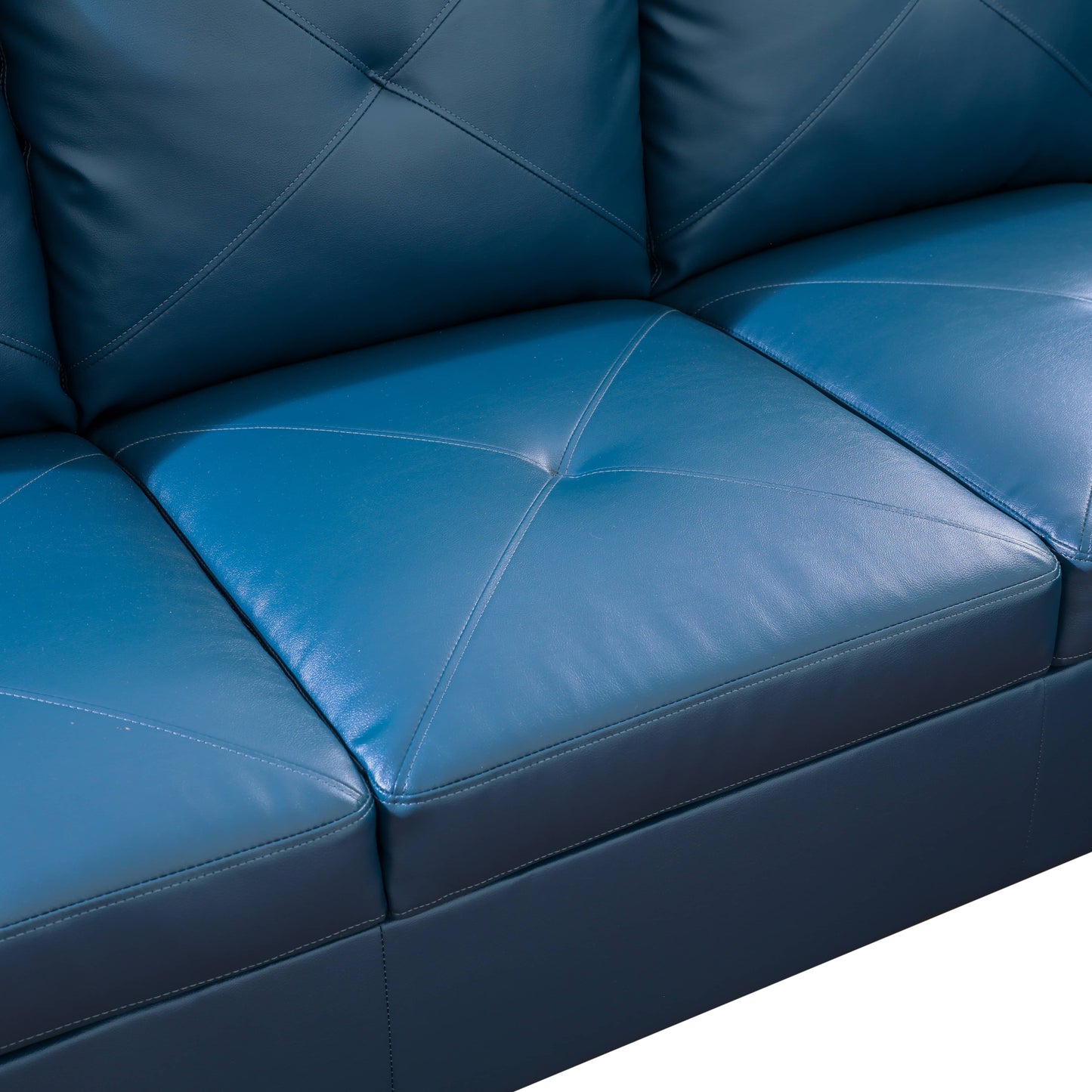 Closeup of deep blue leather sofa with diamond tufting
