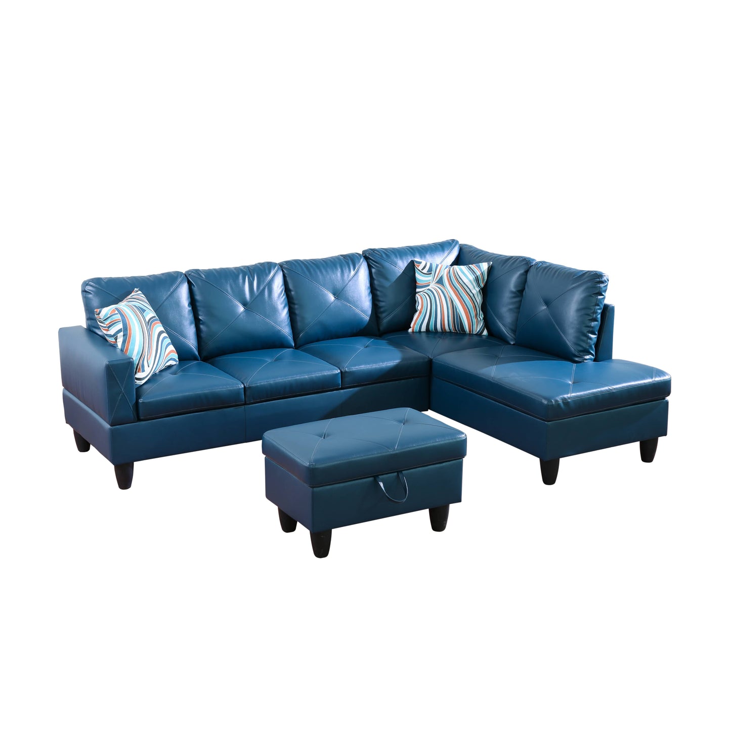 Dark blue faux leather sectional sofa with tufted cushions and patterned throw pillows