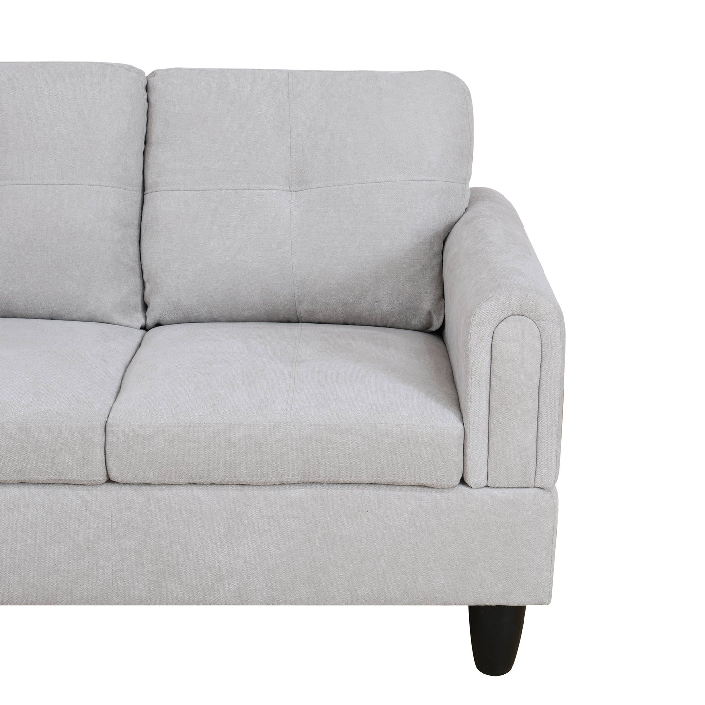 Light gray fabric sofa with tufted back cushions and curved armrest