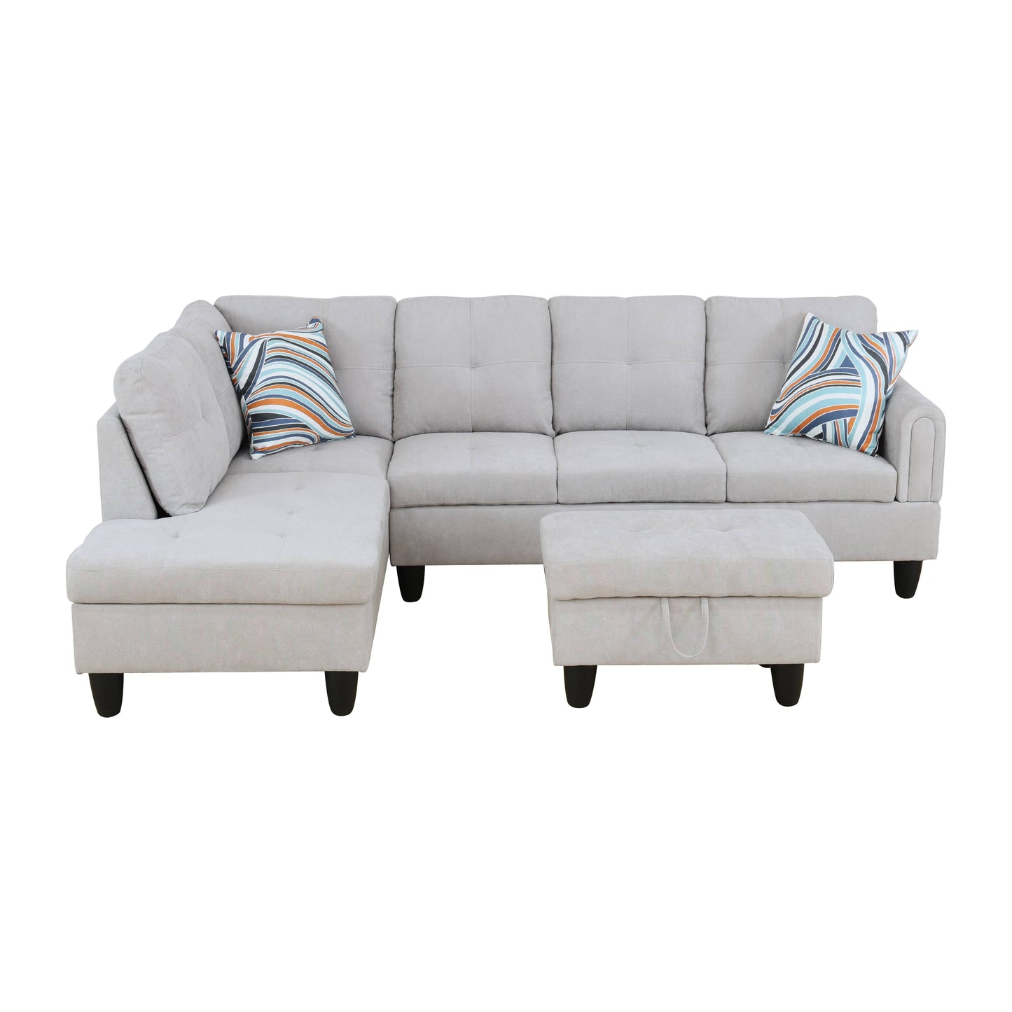 Light grey fabric sectional sofa with patterned throw pillows and matching ottoman