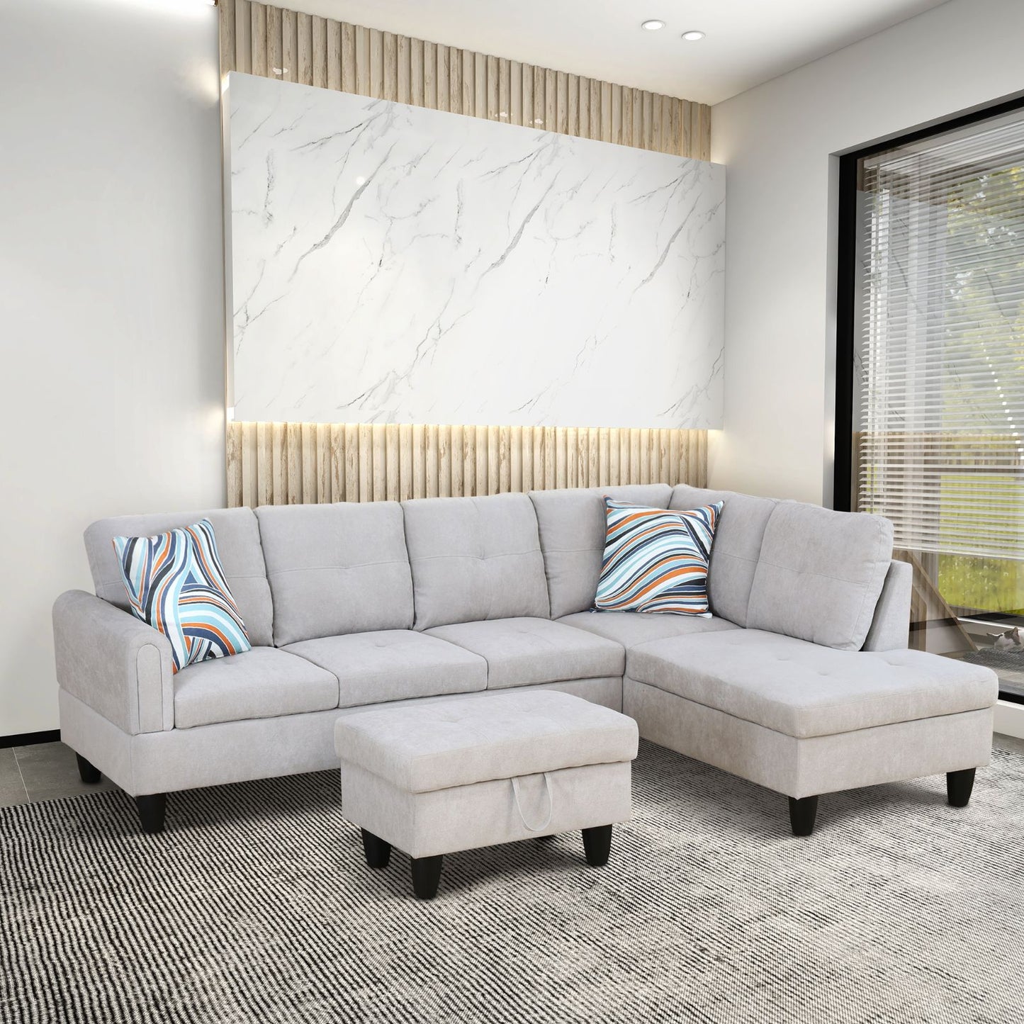 Light gray fabric sectional sofa with ottoman and modern pillows