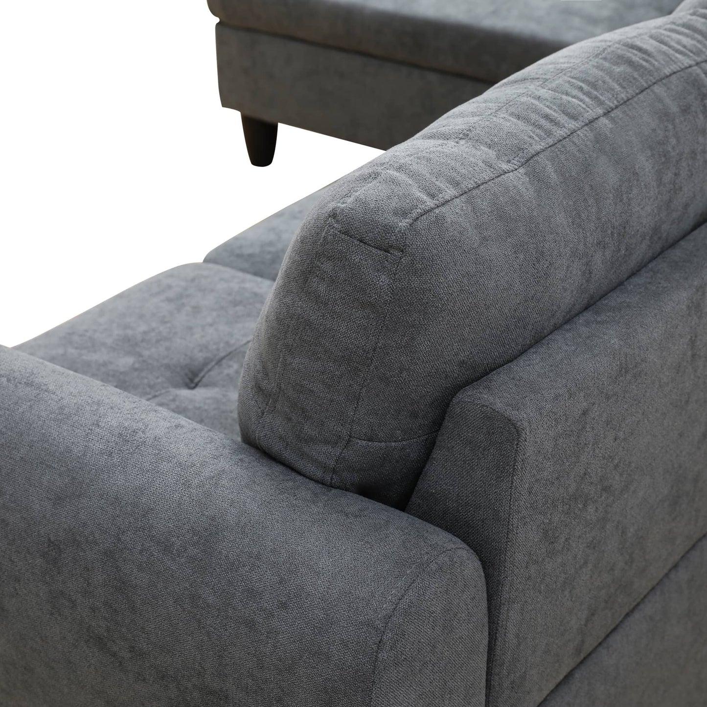 Closeup of a textured grey fabric sofa armrest