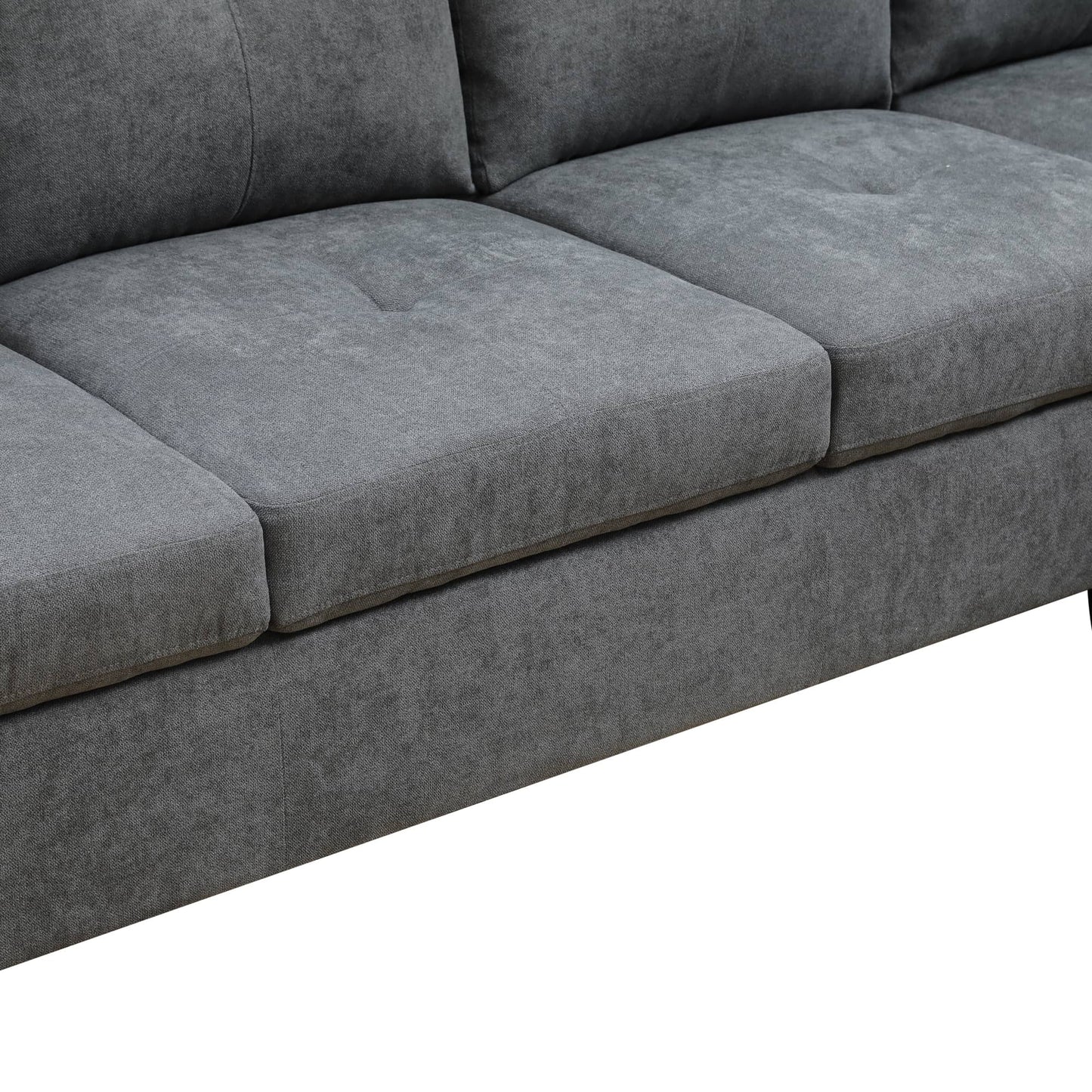 Closeup of grey fabric sofa cushions with subtle tufting