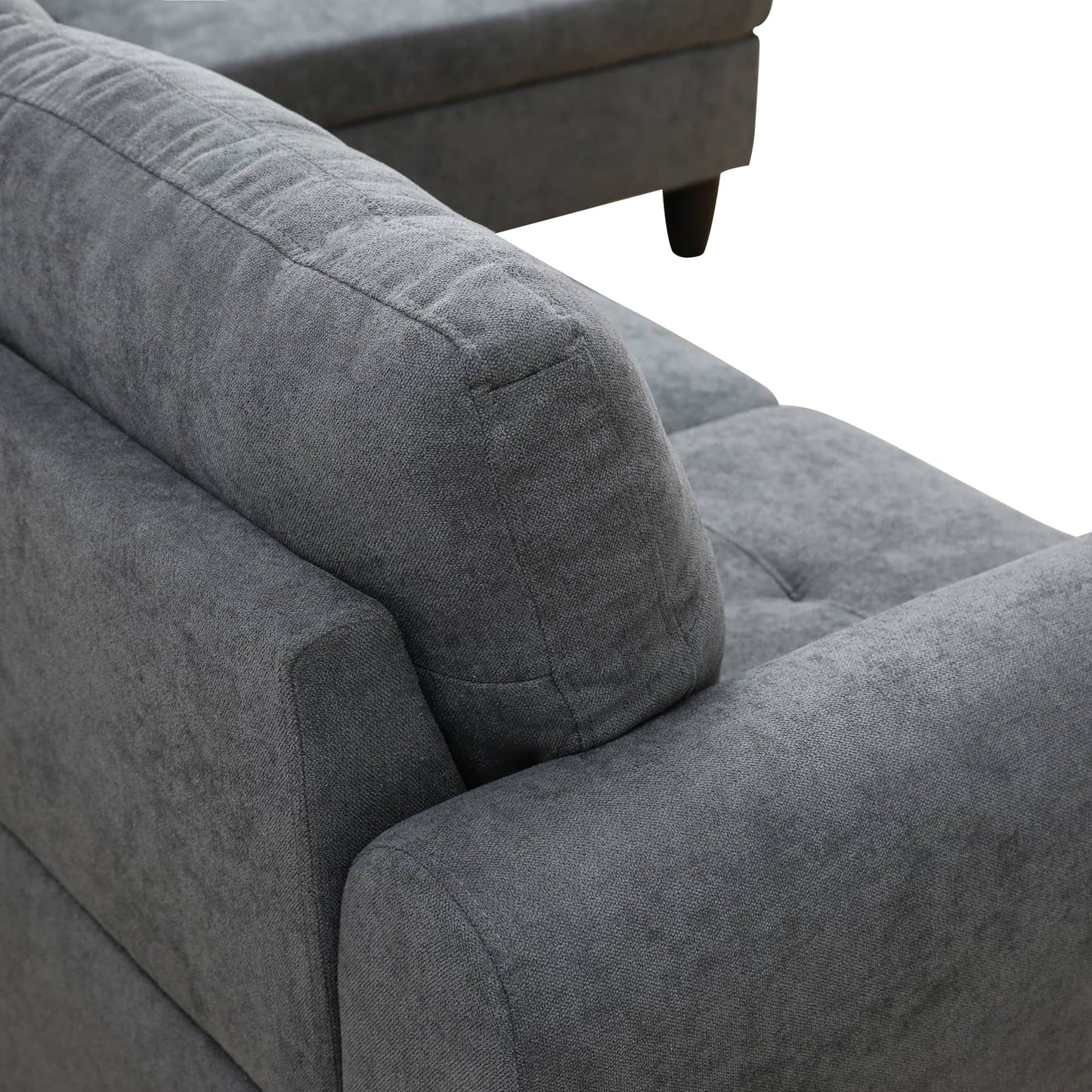 Closeup of textured gray fabric on a modern sectional sofa armrest