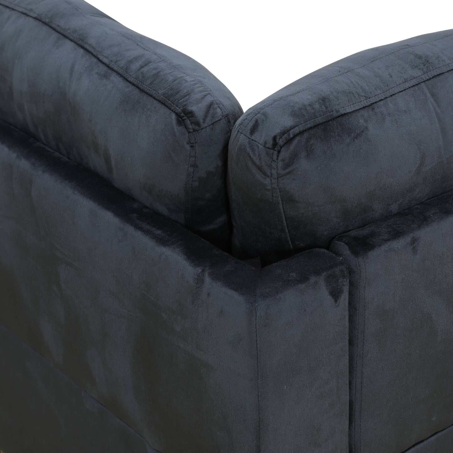Closeup of dark grey velvet sectional sofa corner