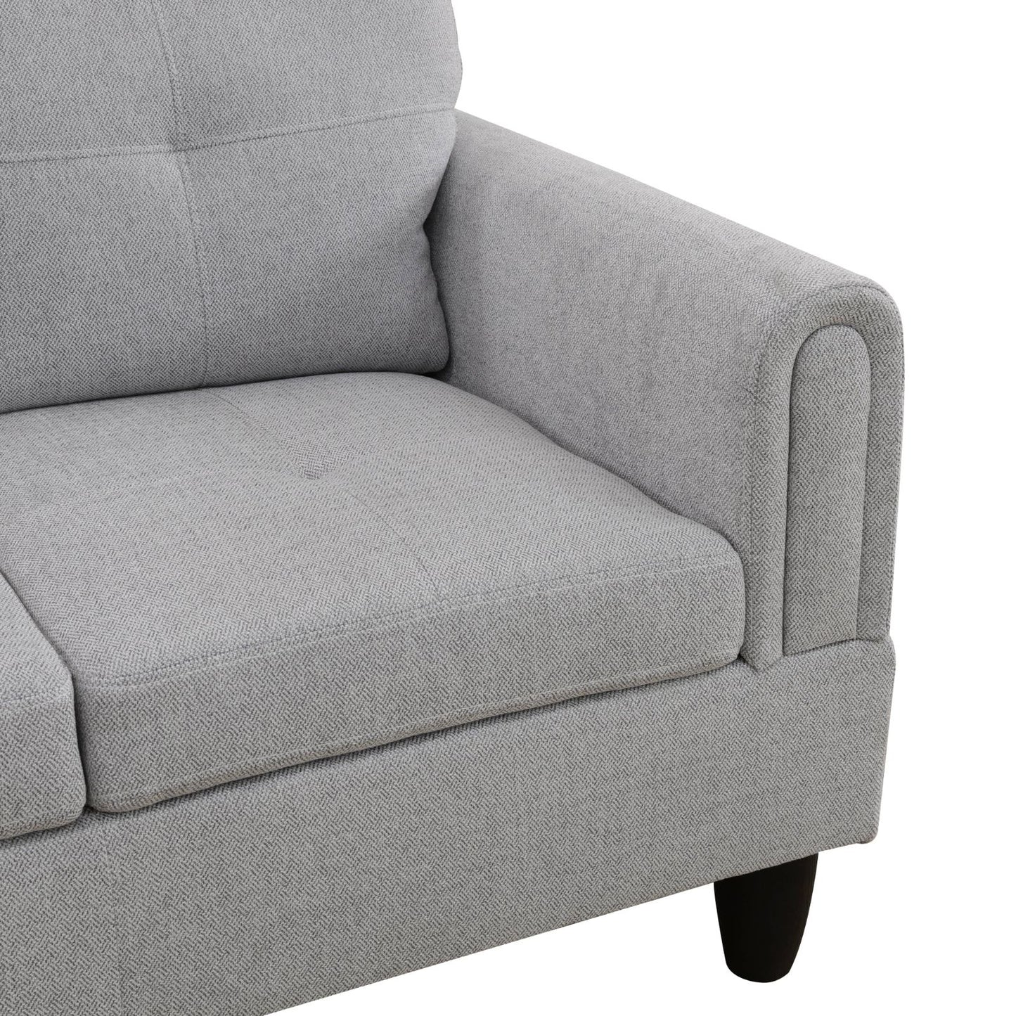 Gray fabric sofa armrest with piped trim detail
