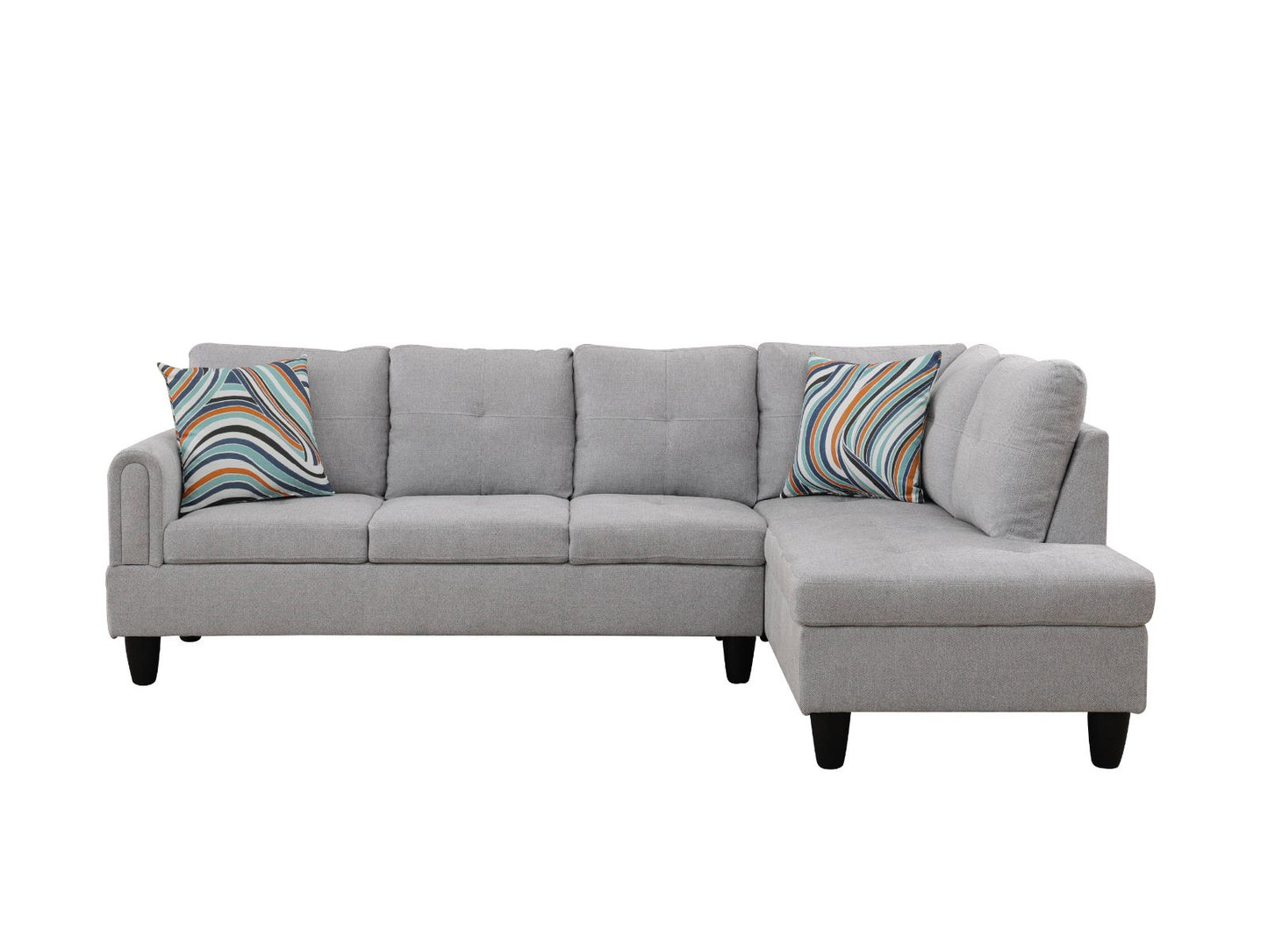 Grey fabric sectional sofa with tufted cushions and colorful throw pillows