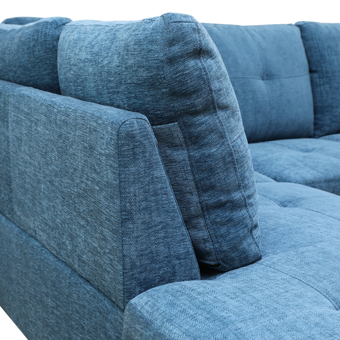 Closeup of textured blue fabric on a modern sectional sofa armrest